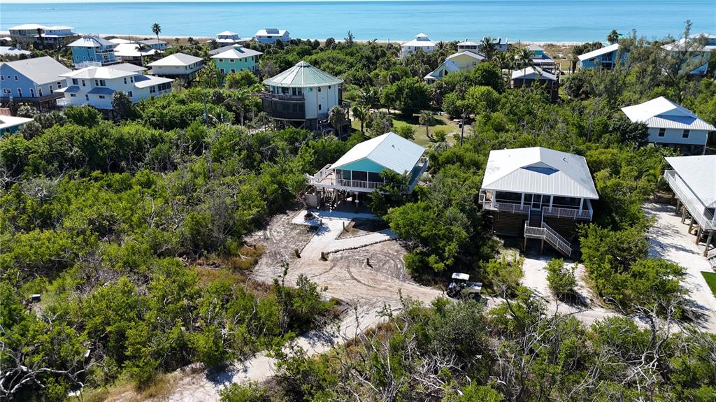 9568 Buccaneer Trail Boca Grande, FL 33921 - Photo 6 of 49 an aerial view of a house with a yard and lake view