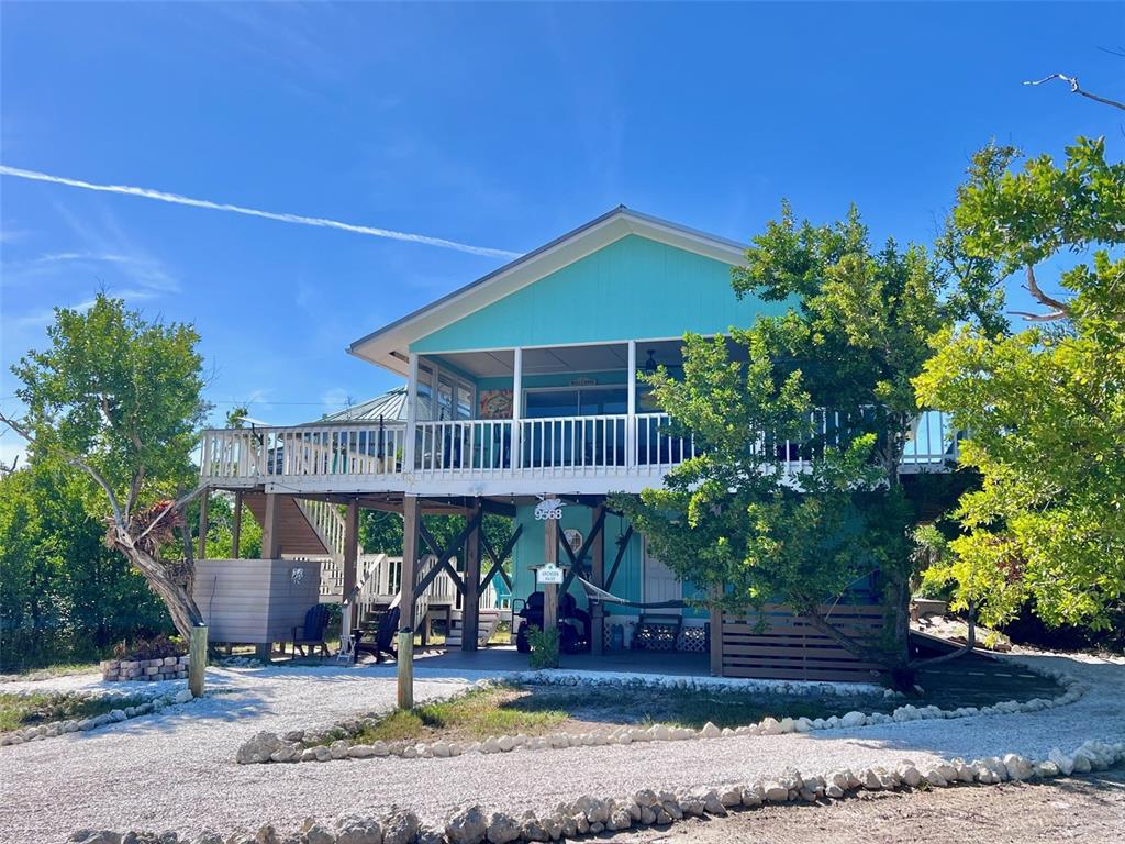 9568 Buccaneer Trail Boca Grande, FL 33921 - Photo 8 of 49 a front view of a house with garden
