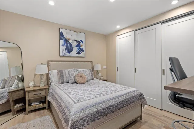 a bathroom with a granite countertop sink a toilet and shower
