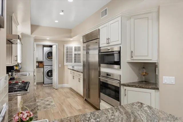 a large kitchen with granite countertop a stove and a sink