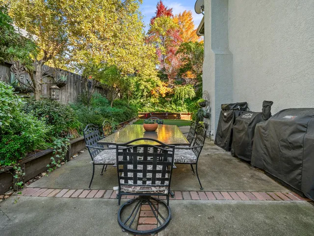 a kitchen with white cabinets and wooden floors