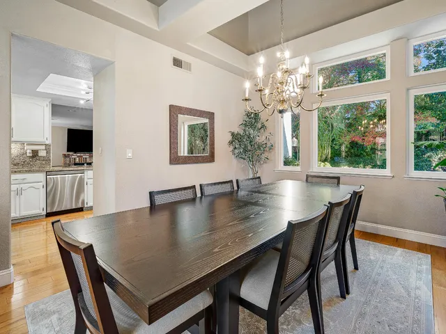a living room with furniture a table and a large window