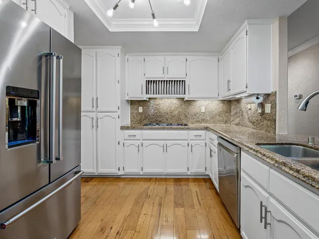 a view of a kitchen counter space cabinets and appliances