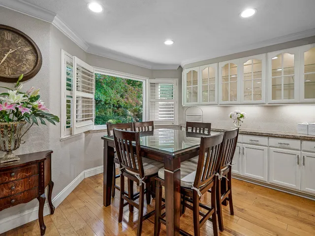 a kitchen with granite countertop a stove a sink and a refrigerator