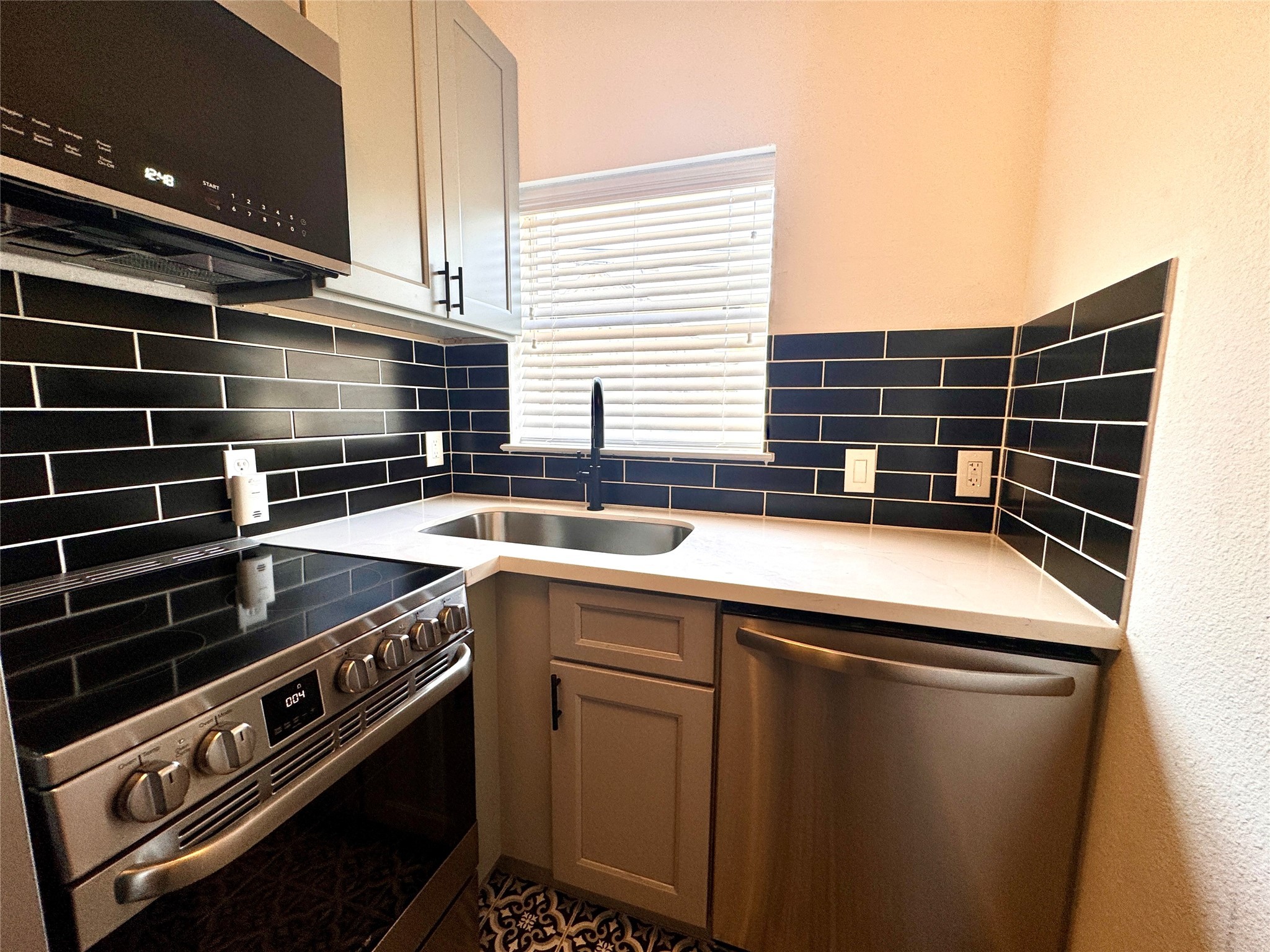 415 Fairview Street, Unit 4 Houston, TX 77006 - Photo 5 of 10 Great looking updated kitchen with black subway tile backsplash, good storage and natural light.