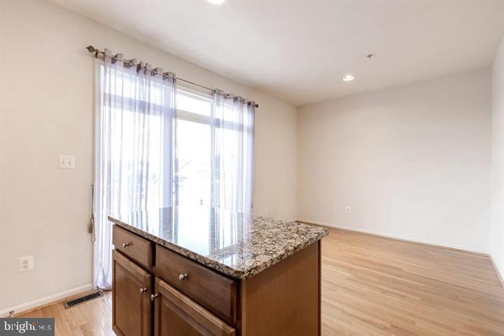 11843 Skylark Road Clarksburg, MD 20871 - Photo 12 of 31 a view of an empty room with wooden floor and a window