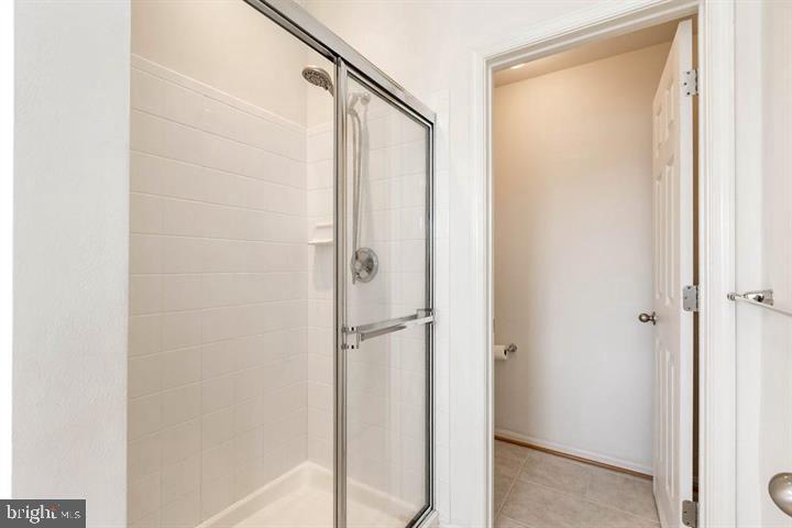 11843 Skylark Road Clarksburg, MD 20871 - Photo 18 of 31 a bathroom with a glass shower door