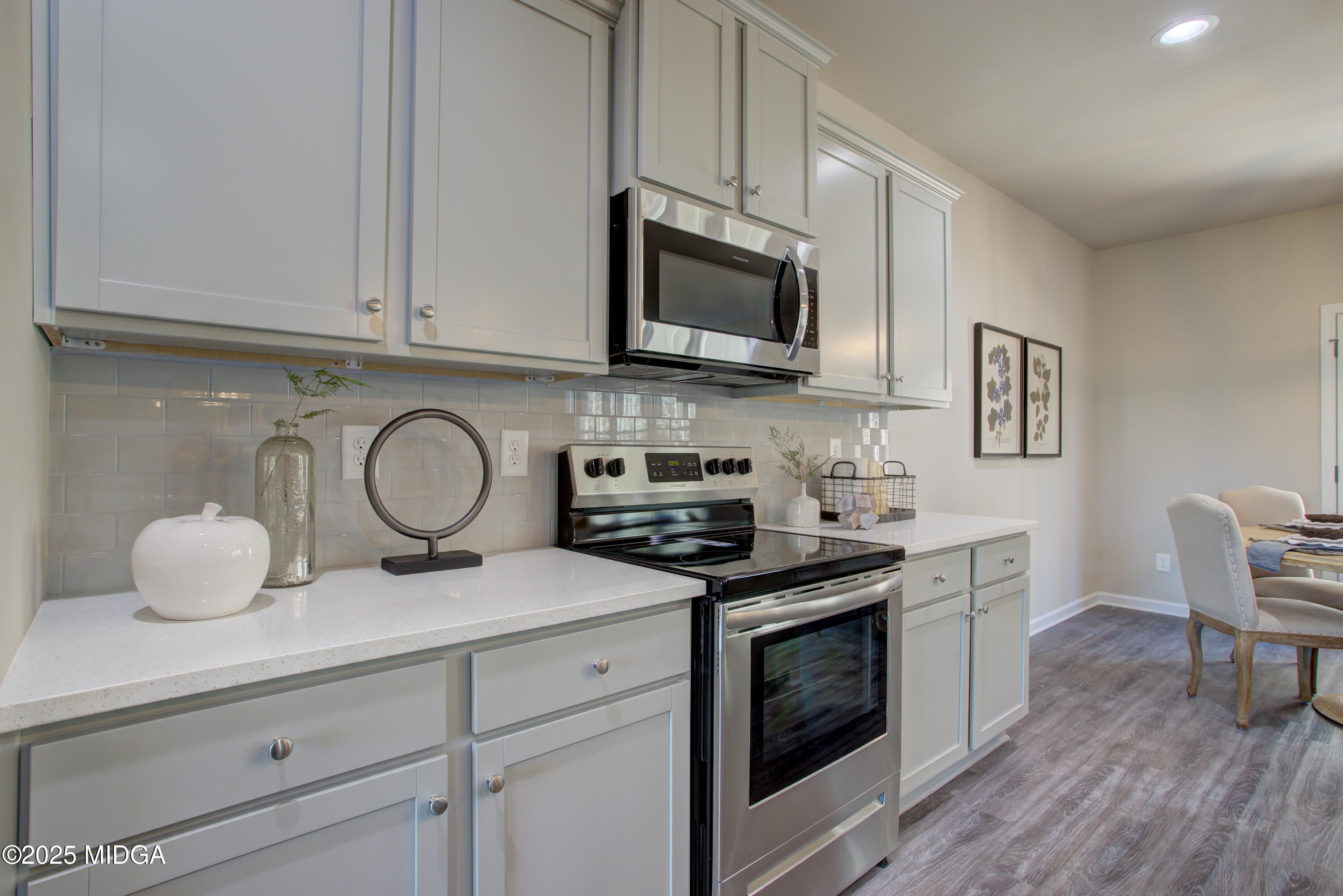 128 Bramblewood Lane Perry, GA 31069 - Photo 12 of 52 a kitchen with white cabinets stainless steel appliances and wooden floor