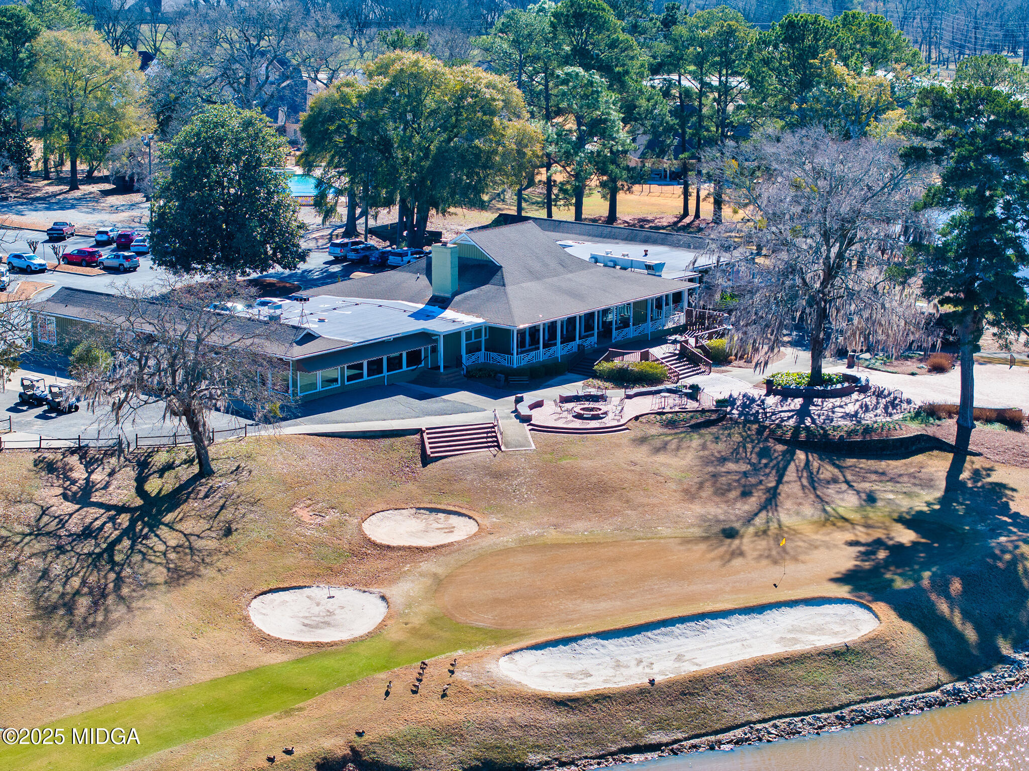128 Bramblewood Lane Perry, GA 31069 - Photo 47 of 52 a view of a backyard with table and chairs potted plants and large tree