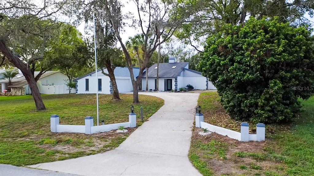 7984 Floral Drive Weeki Wachee, FL 34607 - Photo 1 of 31 a view of a house with garden