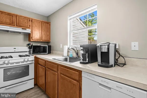 a kitchen with a sink appliances and a window