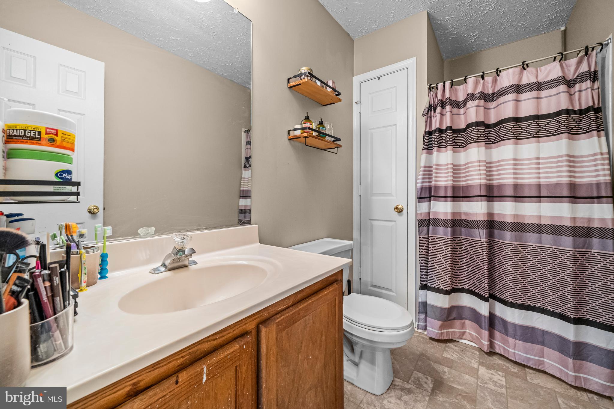 5818 Springfish Place Waldorf, MD 20603 - Photo 18 of 31 a bathroom with a sink a toilet and shower