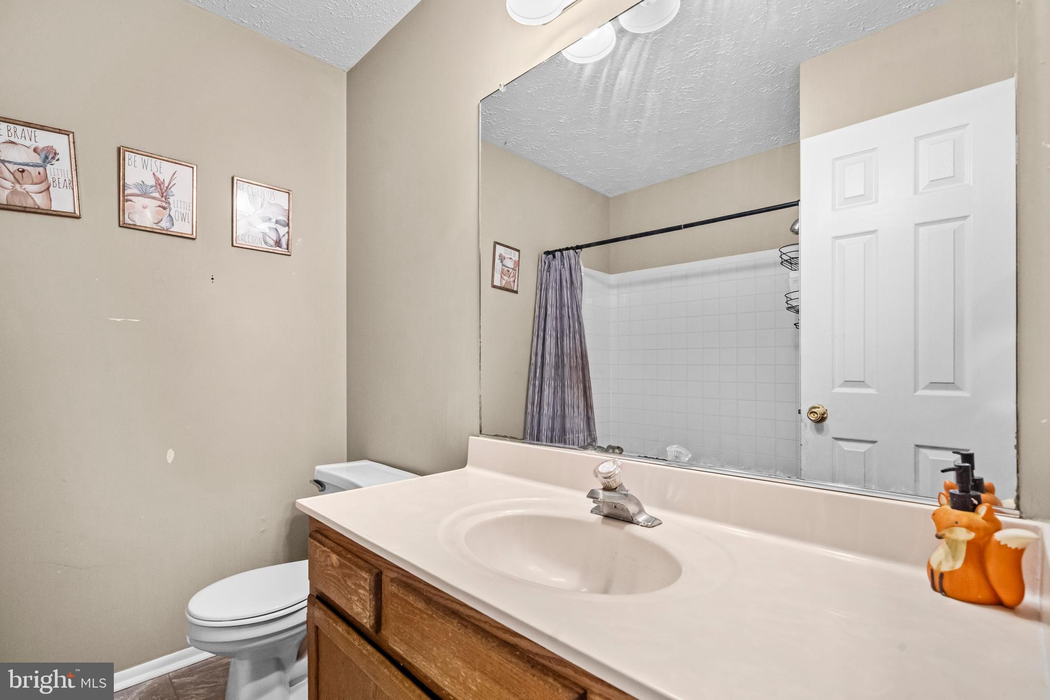 5818 Springfish Place Waldorf, MD 20603 - Photo 22 of 31 a bathroom with a sink toilet and shower