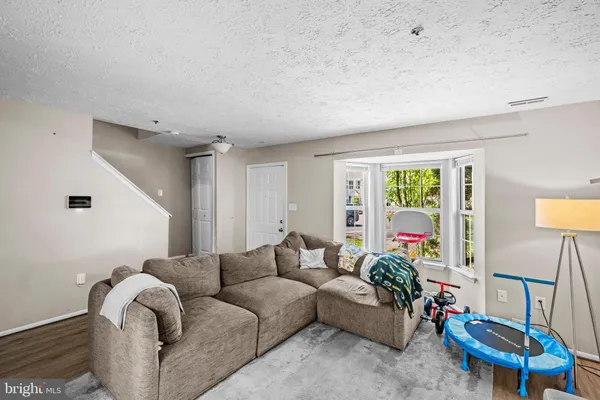 a living room with furniture a rug and a window