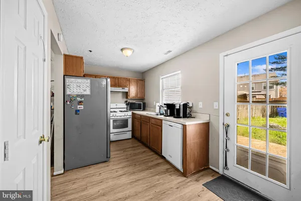 a kitchen with appliances cabinets and a window
