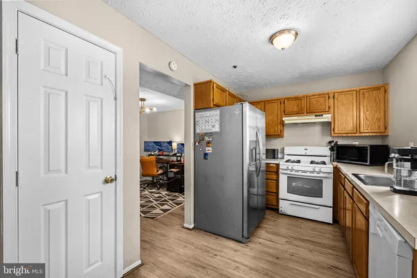 a white stove top oven sitting inside of a kitchen