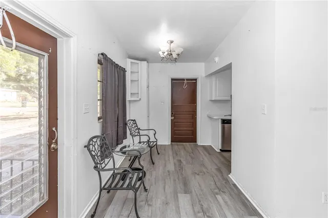 a view of a room with furniture and wooden floor