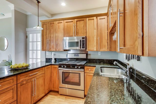 5626 North Ridge Avenue Chicago, IL 60660 - Photo 11 of 27 a kitchen with stainless steel appliances granite countertop a sink a stove and a microwave