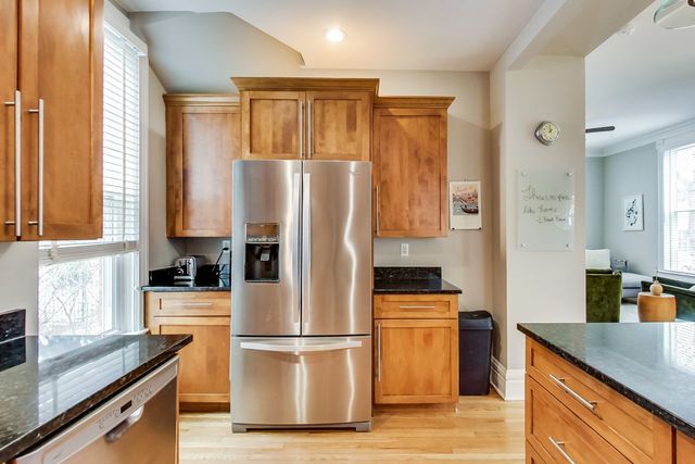 5626 North Ridge Avenue Chicago, IL 60660 - Photo 12 of 27 a kitchen with stainless steel appliances a refrigerator sink and cabinets