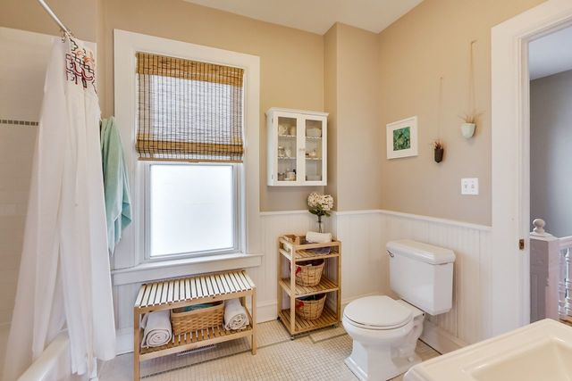 5626 North Ridge Avenue Chicago, IL 60660 - Photo 17 of 27 a bathroom with a toilet a sink and a window