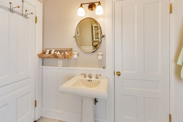 5626 North Ridge Avenue Chicago, IL 60660 - Photo 18 of 27 a bathroom with a sink and a mirror