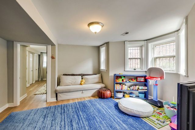 5626 North Ridge Avenue Chicago, IL 60660 - Photo 21 of 27 a living room with furniture and a wooden floor
