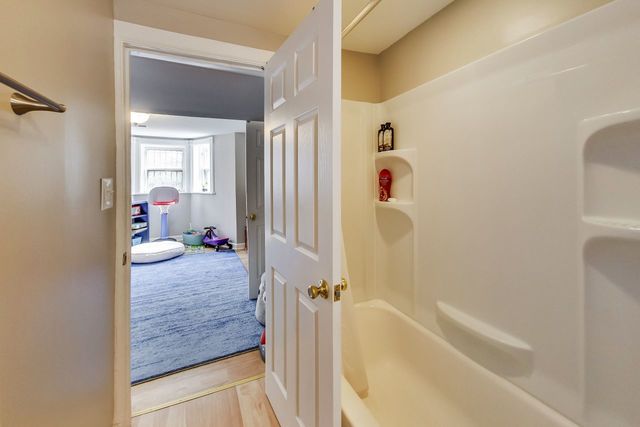 5626 North Ridge Avenue Chicago, IL 60660 - Photo 23 of 27 a bathroom with a granite countertop tub shower and a sink