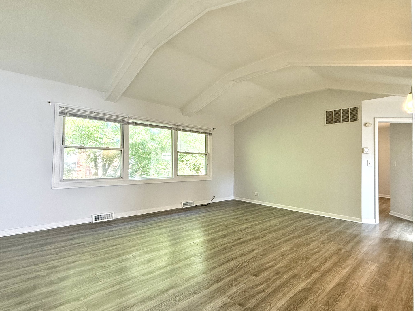 231 Callan Avenue, Unit 2N Evanston, IL 60202 - Photo 2 of 8 a view of an empty room with wooden floor and a window