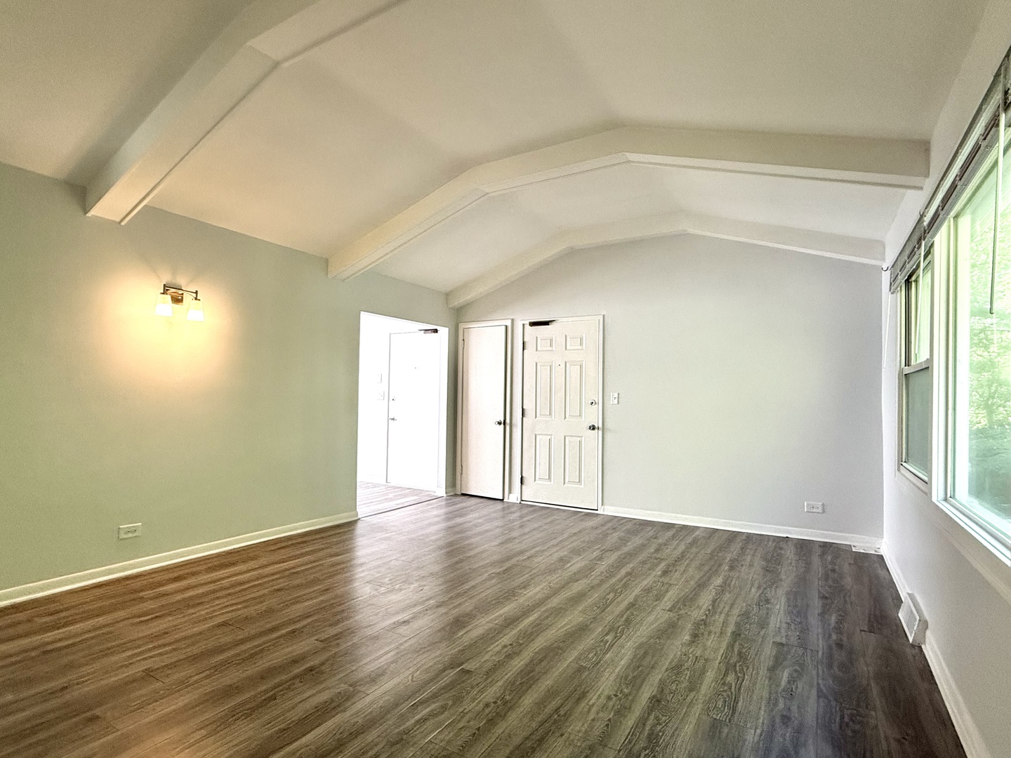 231 Callan Avenue, Unit 2N Evanston, IL 60202 - Photo 3 of 8 wooden floor in an empty room with a window