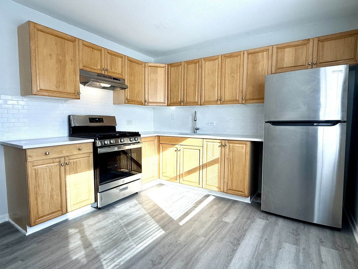 231 Callan Avenue, Unit 2N Evanston, IL 60202 - Photo 4 of 8 a kitchen with a stove a sink and a refrigerator