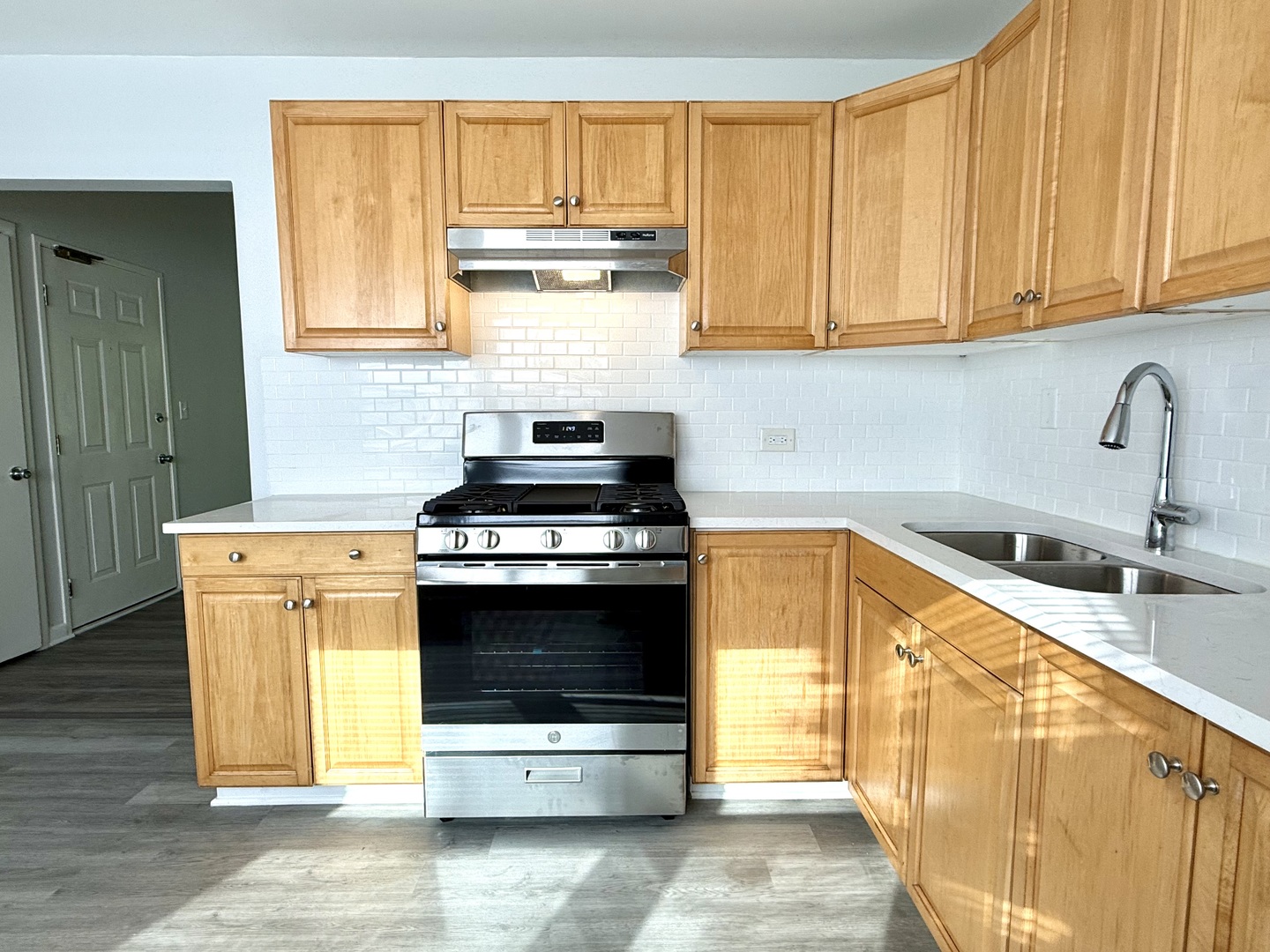 231 Callan Avenue, Unit 2N Evanston, IL 60202 - Photo 5 of 8 a kitchen with stainless steel appliances granite countertop a stove a sink and a microwave