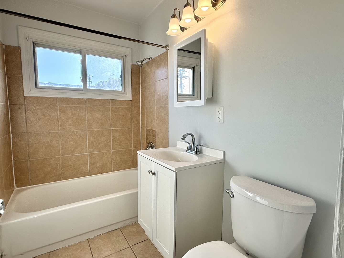 231 Callan Avenue, Unit 2N Evanston, IL 60202 - Photo 6 of 8 a bathroom with a sink a toilet and bathtub