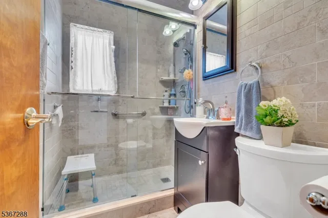 a bathroom with a sink mirror vanity and toilet