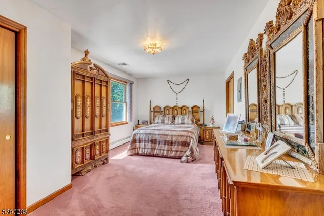 a bedroom with furniture and a large window