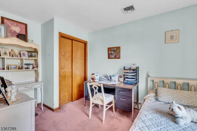 a reading room with furniture and a book shelf