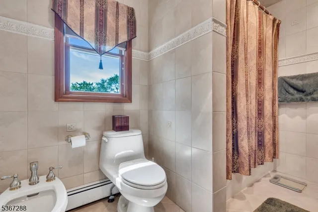 a white toilet sitting next to a bathroom sink
