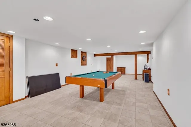 a room with pool table and glass windows
