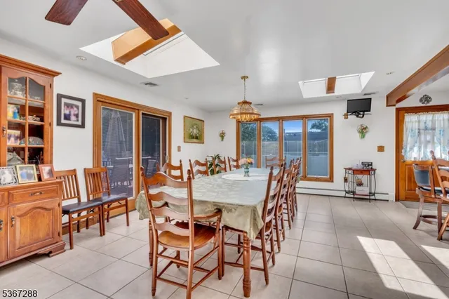 a dining room with furniture and floor to ceiling window
