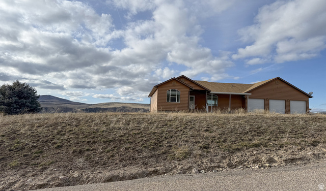354 East Lower Rock Creek Road Inkom, ID 83245 - Photo 1 of 1 Single story home with log veneer siding, a mountain view, and a garage