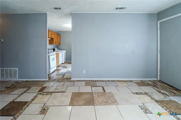 a kitchen with a stove top oven sink and cabinets