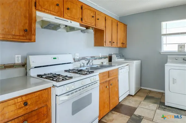 a white refrigerator freezer sitting inside of a kitchen