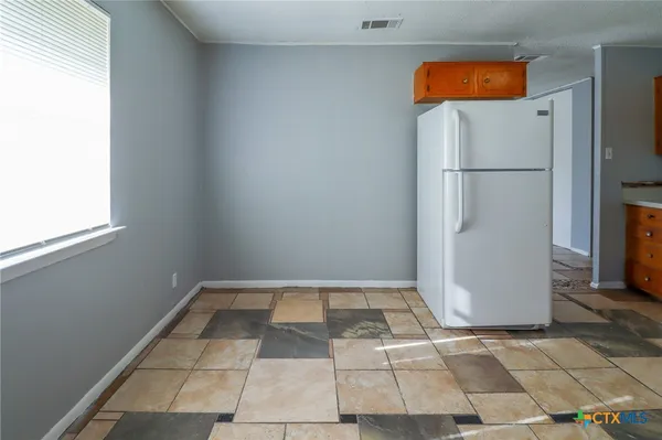 a view of empty room with white walls