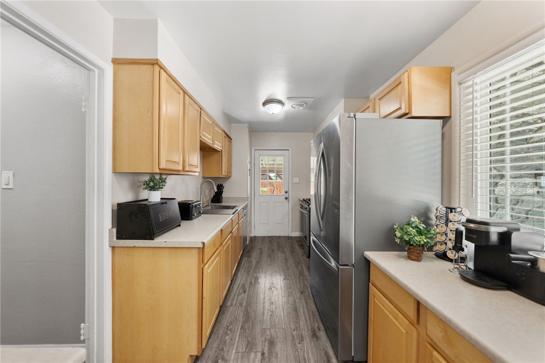 4869 Serrano Place Riverside, CA 92504 - Photo 20 of 40 Galley-style kitchen offering plenty of workspace, natural light, and a practical layout with ample storage.