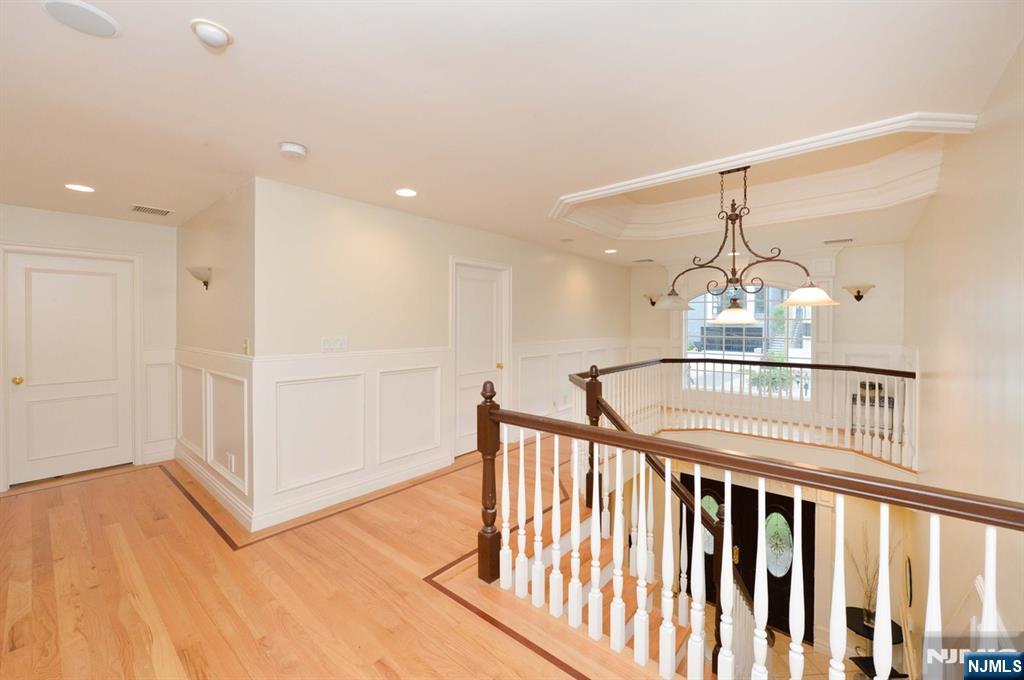 2186 Jones Road Fort Lee, NJ 07024 - Photo 16 of 27 a view of a hallway with a chandelier