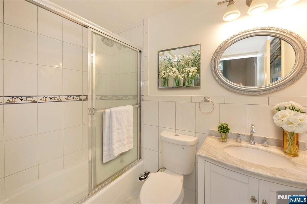 2186 Jones Road Fort Lee, NJ 07024 - Photo 20 of 27 a bathroom with a toilet a sink and a mirror