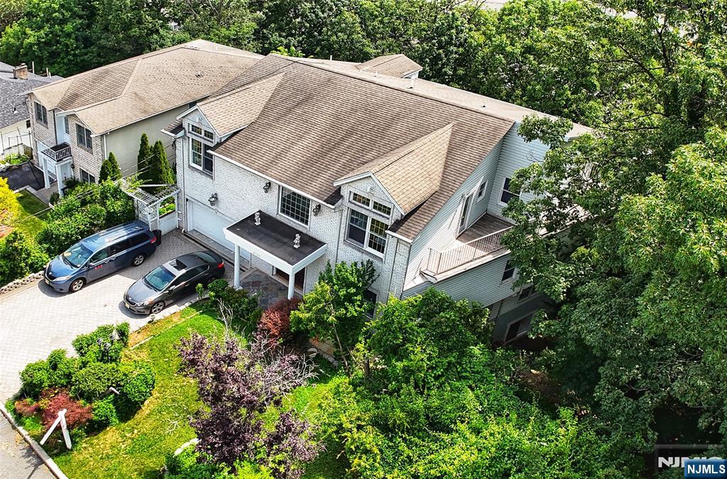2186 Jones Road Fort Lee, NJ 07024 - Photo 2 of 27 an aerial view of a house with a yard and large trees