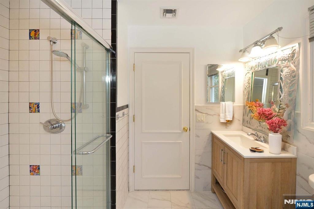 2186 Jones Road Fort Lee, NJ 07024 - Photo 23 of 27 a bathroom with a sink vanity and shower