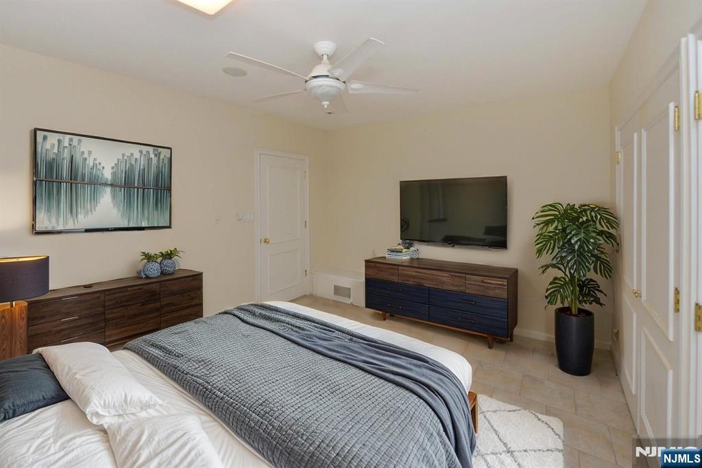 2186 Jones Road Fort Lee, NJ 07024 - Photo 26 of 27 a bedroom with a bed and a flat screen tv