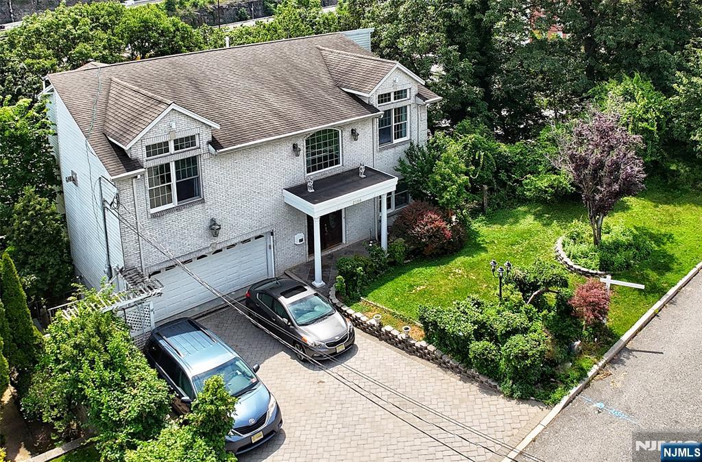 2186 Jones Road Fort Lee, NJ 07024 - Photo 3 of 27 a aerial view of a house with a yard plants and large tree