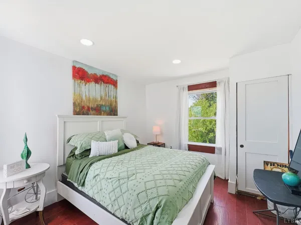 a bedroom with a bed and a desk